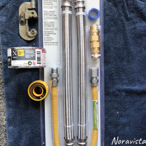 A water tank installation kit with flexible hoses and a gas hose