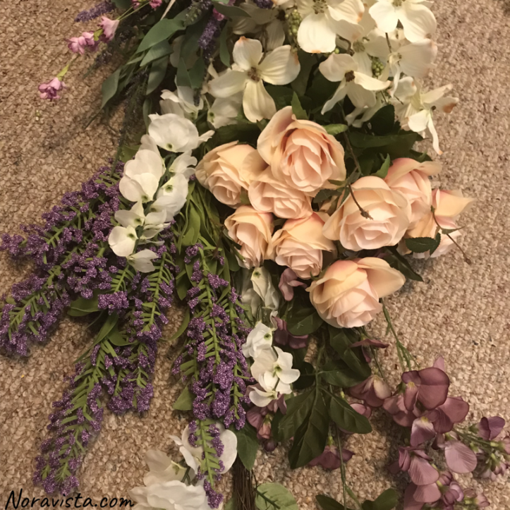 Fake flowers and vines in light pink, purple, white and green